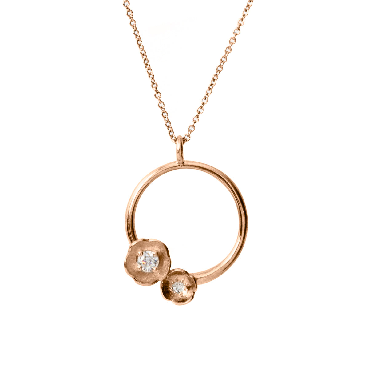 circular pendant in rose gold featuring two flowers set with diamonds
