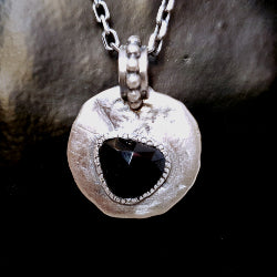 Organic textured, round and flat pendant in silver set with rose cut  black spinel